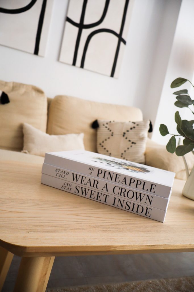 decorative books stacked on a coffee table with candles