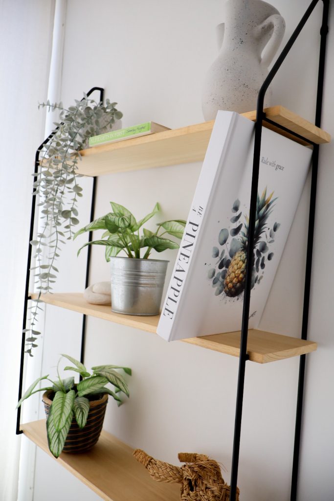 faux books styled on a bookshelf with accessories