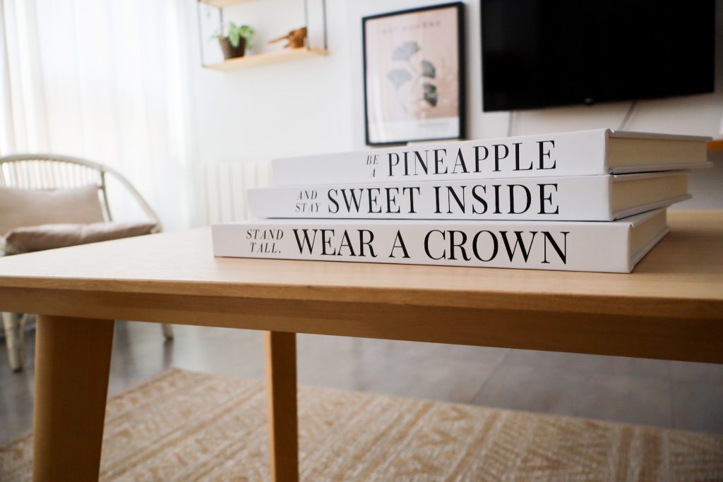 decorative books stacked on a coffee table with candles